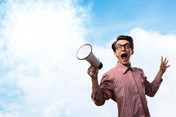 Young man shouting using megaphone — Stock Photo, Image