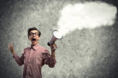 man yells into a megaphone