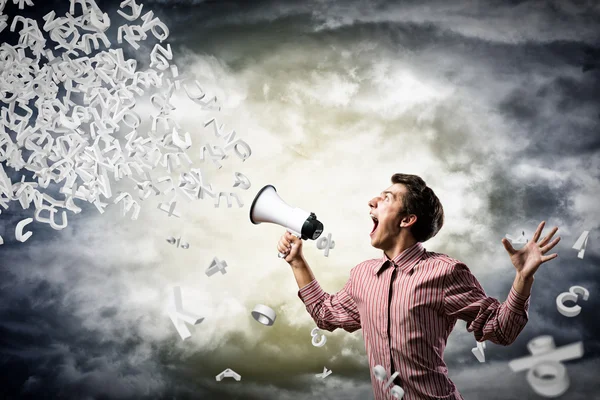Man yells into a megaphone — Stockfoto