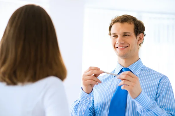 Businessman holds up a pen — Stock Photo, Image