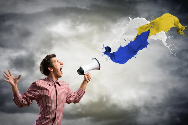 Man yells into a megaphone — Stok fotoğraf