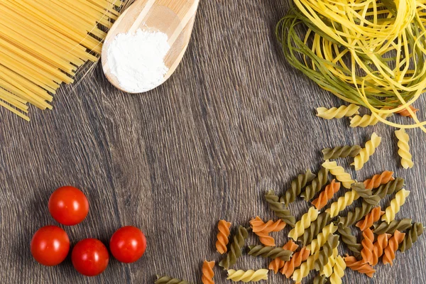 Pasta, tomatoes and flour — Stock Photo, Image