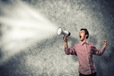 man yells into a megaphone