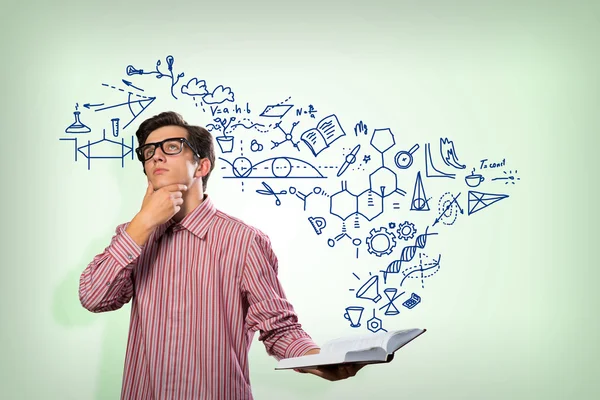 Young scientist holding a book — Stock Photo, Image