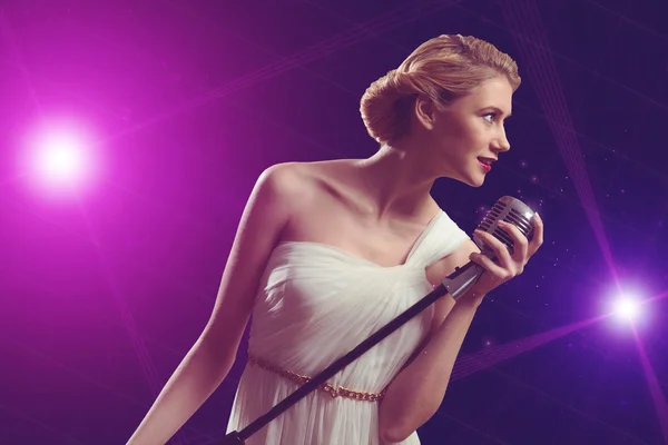 Attractive female singer with microphone — Stock Photo, Image