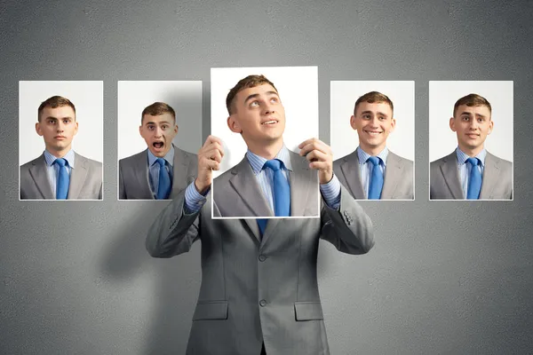 Young man holds up a photograph — Stock Photo, Image