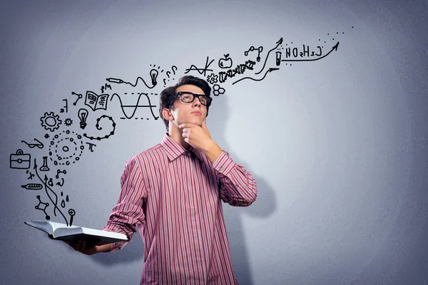 Young scientist holding a book — Stock Photo, Image