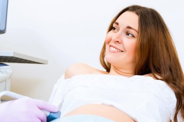 Pregnant woman on reception at the doctor clipart