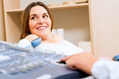 Pregnant woman on reception at the doctor clipart