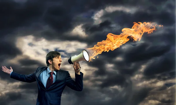 Businessman shouting into a megaphone — Stock Photo, Image