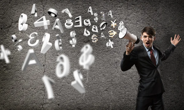 Businessman shouting into a megaphone — Stock Photo, Image