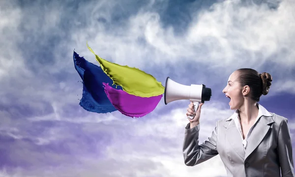 Business woman shouting into a megaphone — Stock Photo, Image