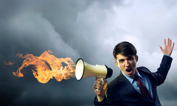 Businessman shouting into a megaphone — Stock Photo, Image