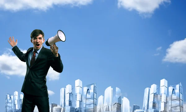 Businessman shouting into a megaphone — Stock Photo, Image