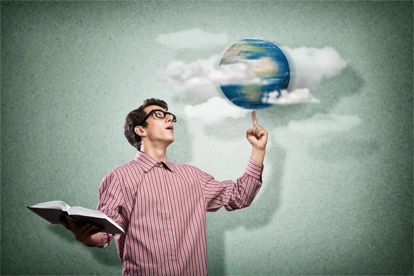 Young man with a book thinks — Stock Photo, Image