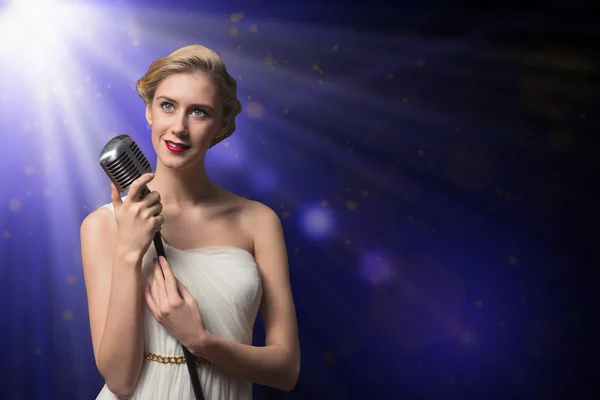 Attractive female singer with microphone — Stock Photo, Image