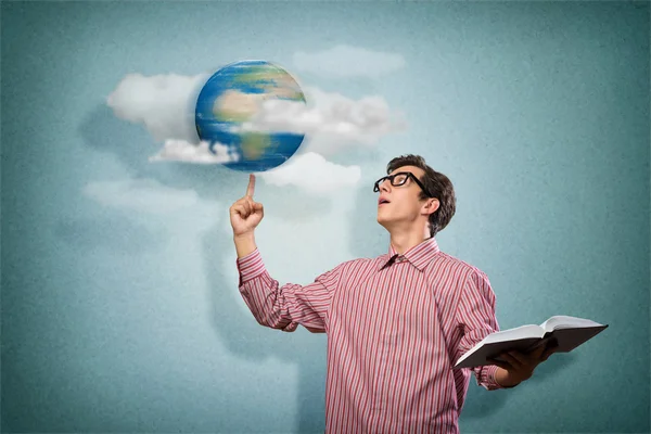 Young man with a book thinks — Stock Photo, Image