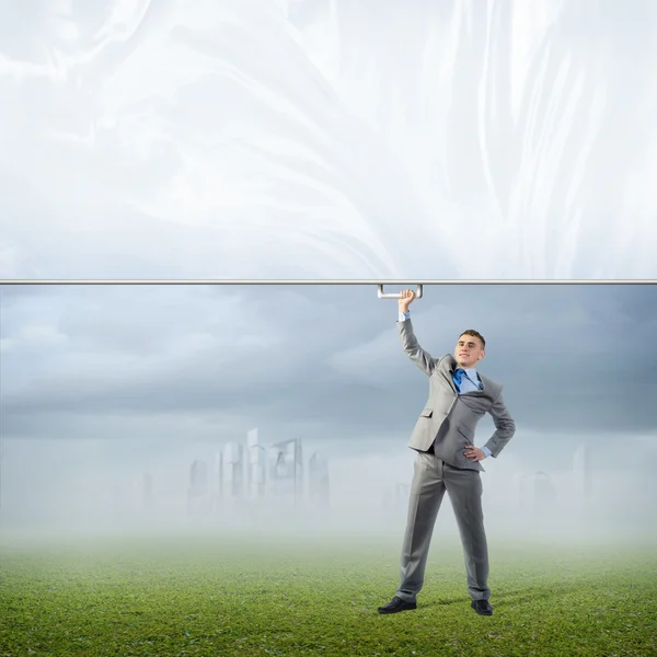 Geschäftsmann hält ein Banner mit einer Hand — Stockfoto