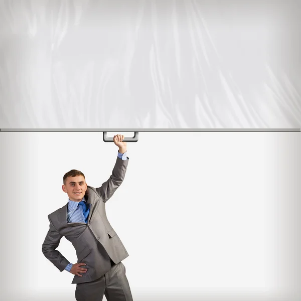 Businessman holding a banner with one hand — Stock Photo, Image