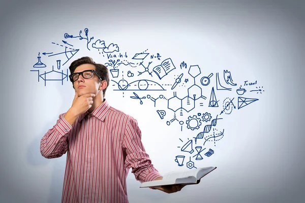 Young scientist holding a book — Stock Photo, Image