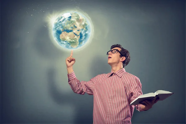 Young man with a book thinks — Stock Photo, Image