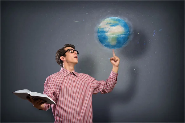 Young man with a book thinks — Stock Photo, Image