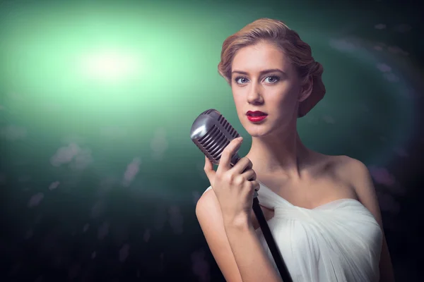 Attractive female singer with microphone — Stock Photo, Image