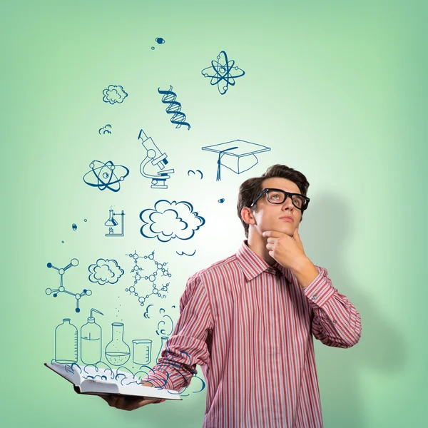 Young scientist holding a book — Stock Photo, Image