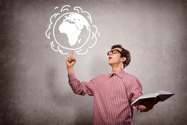 Young man with a book thinks — Stock Photo, Image