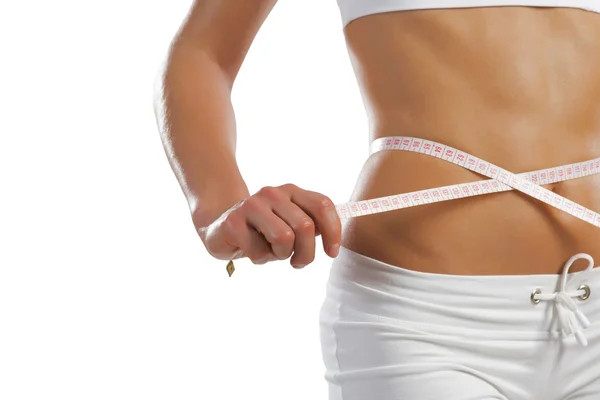 Young athletic woman measuring waist — Stock Photo, Image