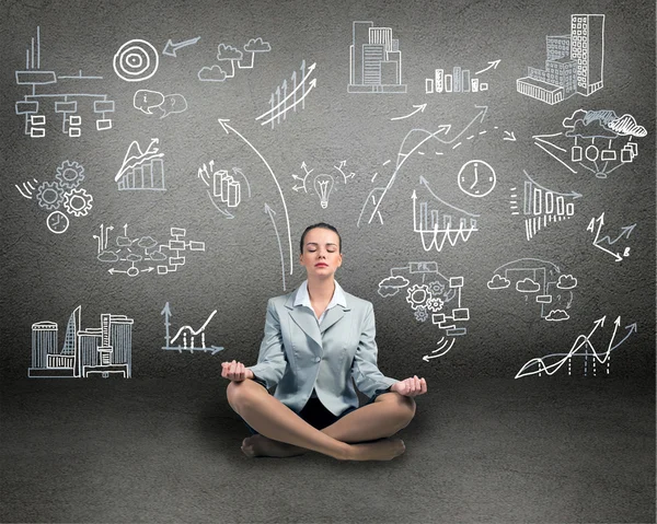 Business woman meditating on floor — Stock Photo, Image
