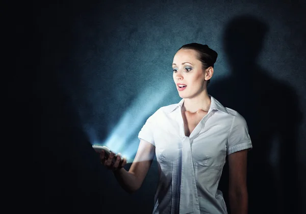 Young attractive woman holding a cell phone — Stock Photo, Image