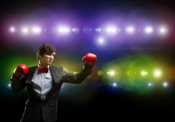 Businessman with boxing gloves in the ring — Stock Photo, Image