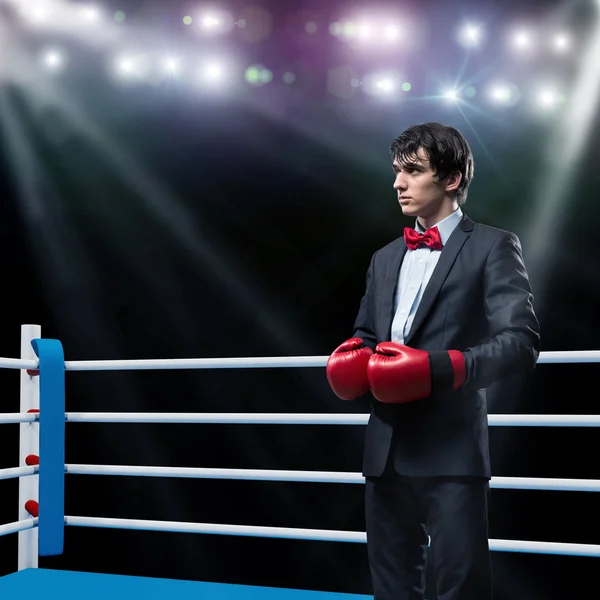 Businessman with boxing gloves in the ring — Stock Photo, Image