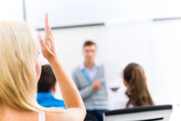 Vrouwelijke hand aan de orde gesteld in de klas — Stockfoto