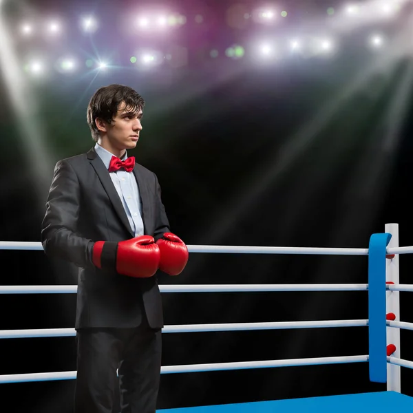 Бизнесмен в боксёрских перчатках на ринге — стоковое фото