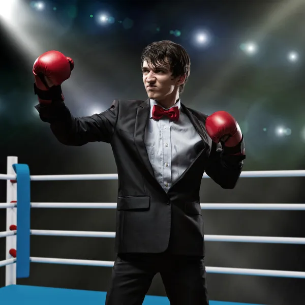 Businessman with boxing gloves in the ring — Stock Photo, Image