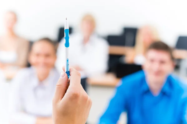 Close-up of hands of a teacher with a pen — Stock Photo, Image