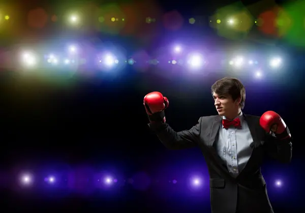 Businessman with boxing gloves in the ring — Stock Photo, Image