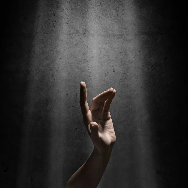 Woman's hand reaches for the light rays — Stock Photo, Image