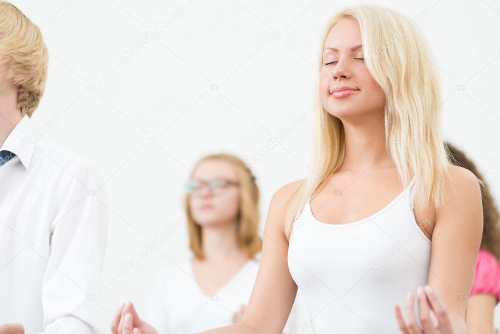 young woman, meditating with closed eyes
