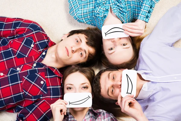 Four young men lie together — Stock Photo, Image