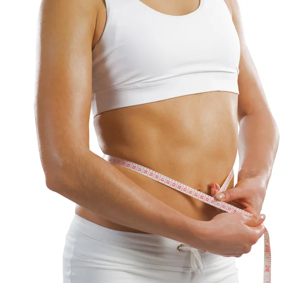 Young athletic woman measuring waist — Stock Photo, Image