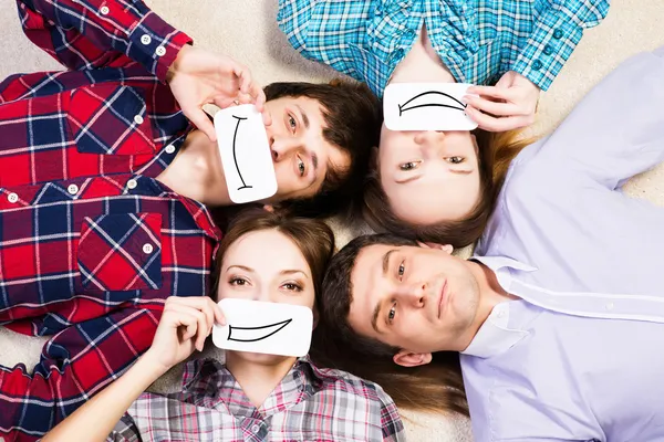 Four young men lie together — Stock Photo, Image