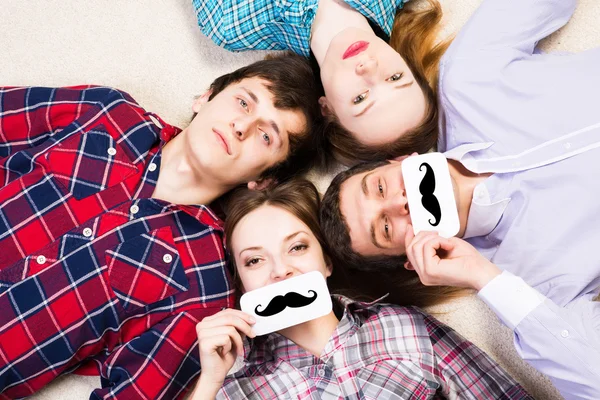 Four young men lie together — Stock Photo, Image