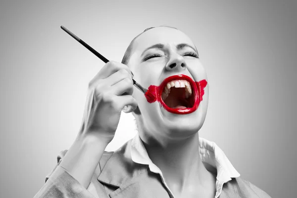 Woman paints her lips — Stock Photo, Image