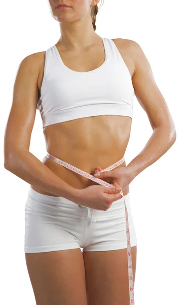 Mulher atlética medindo cintura — Fotografia de Stock