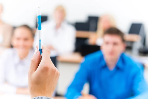 Hands of a teacher with a ballpoint pen — Stock Photo, Image