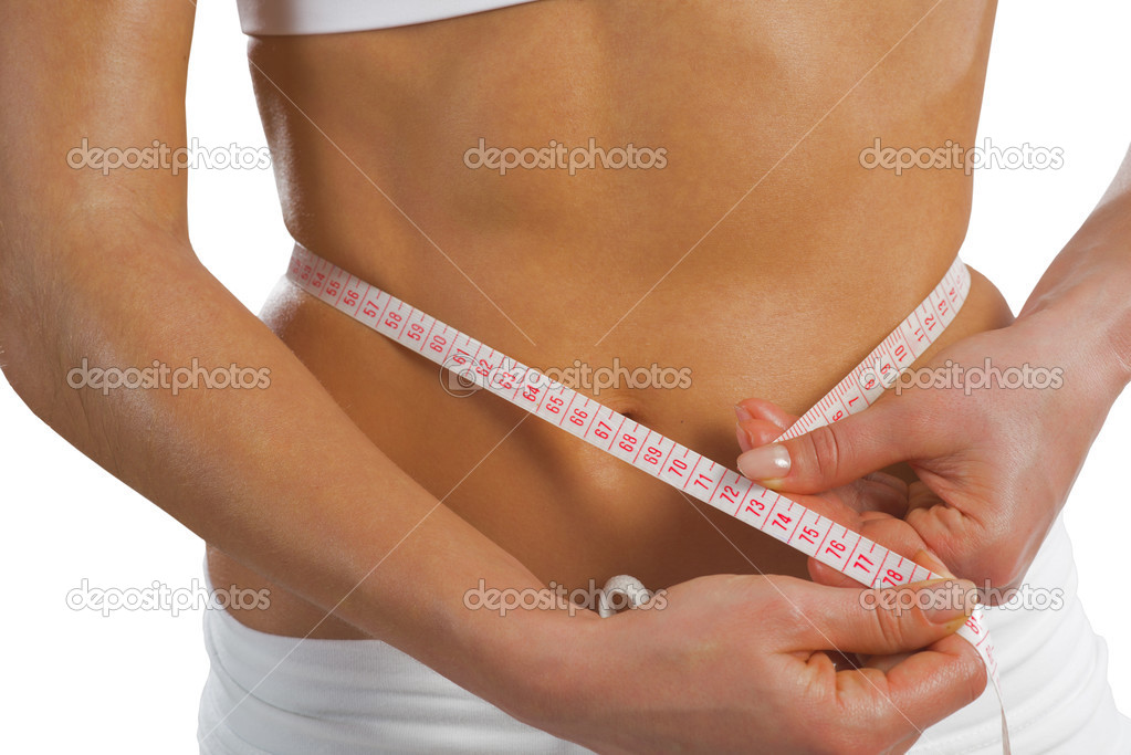 Athletic woman measuring waist