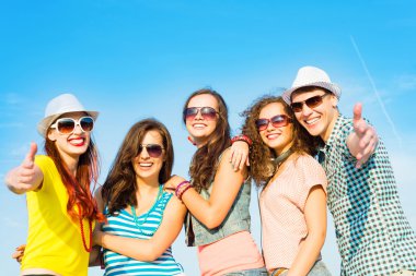 group of young people wearing sunglasses and hat